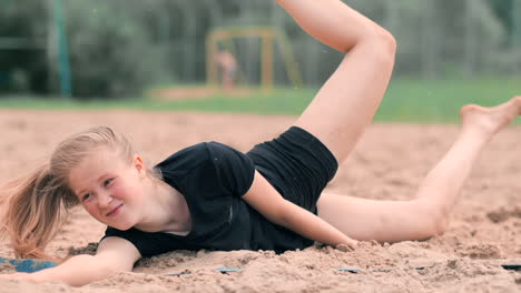 Junge-Sportlerin-Springt-In-Den-Sand-Und-Rettet-Einen-Punkt-Während-Eines-Beachvolleyballspiels.-Fröhliches-Kaukasisches-Mädchen-Springt-Und-Kracht-Während-Eines-Beachvolleyballturniers-In-Den-Weißen-Sand.